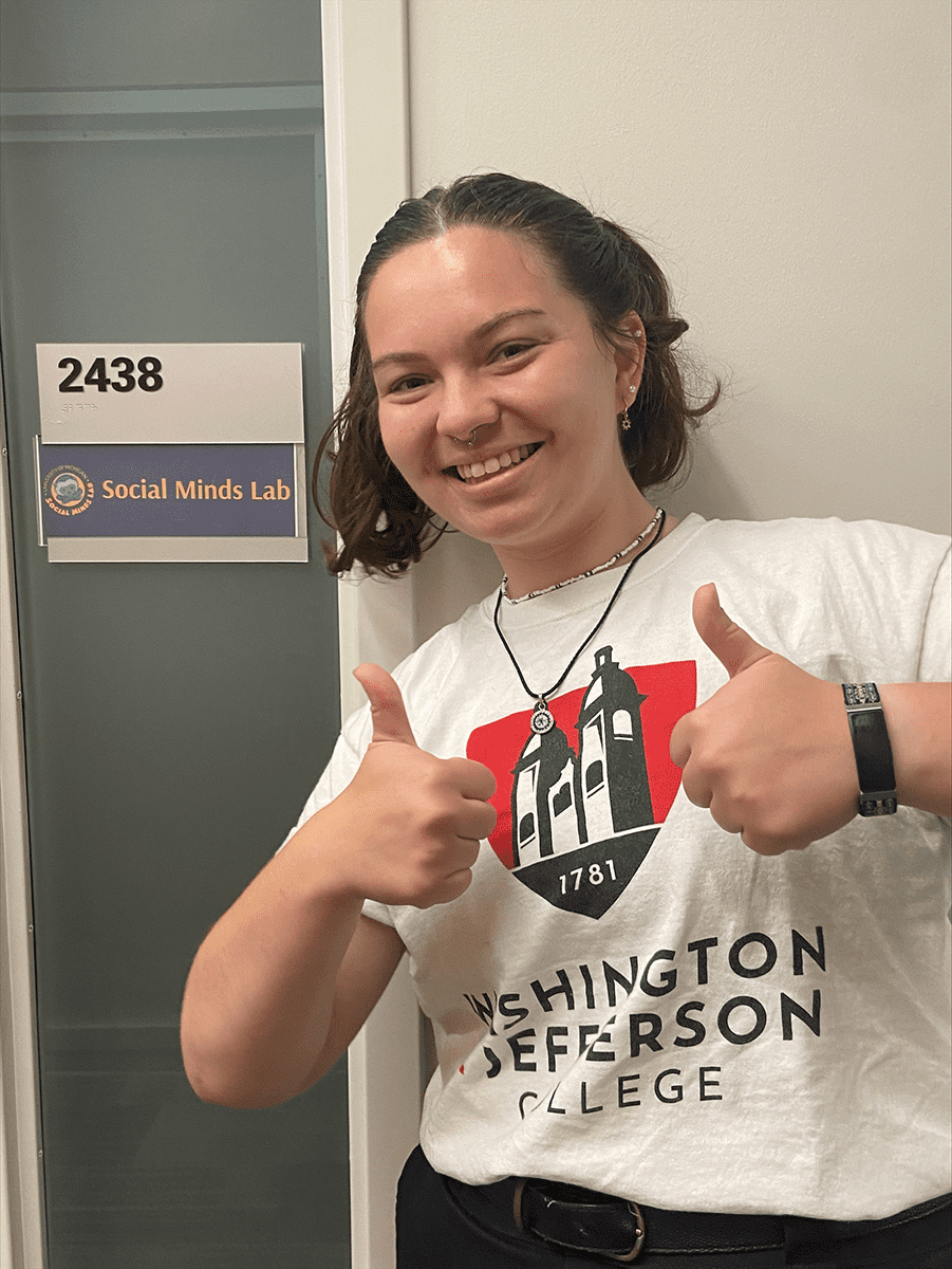 W&J rising senior Julia Hurwitz stands outside of the University of Michigan's Social Minds Lab and gives two thumbs up.