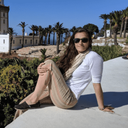 W&J alumna Clara Sherwood poses on a ledge overlooking the sea in Morocco.