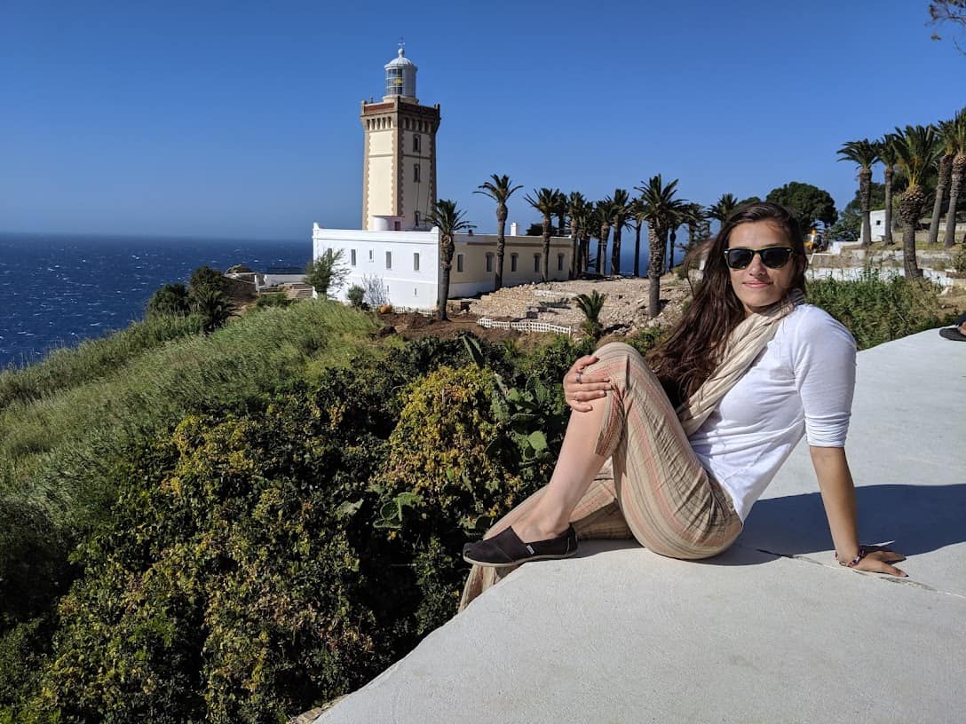 W&J alumna Clara Sherwood poses on a ledge overlooking the sea in Morocco.