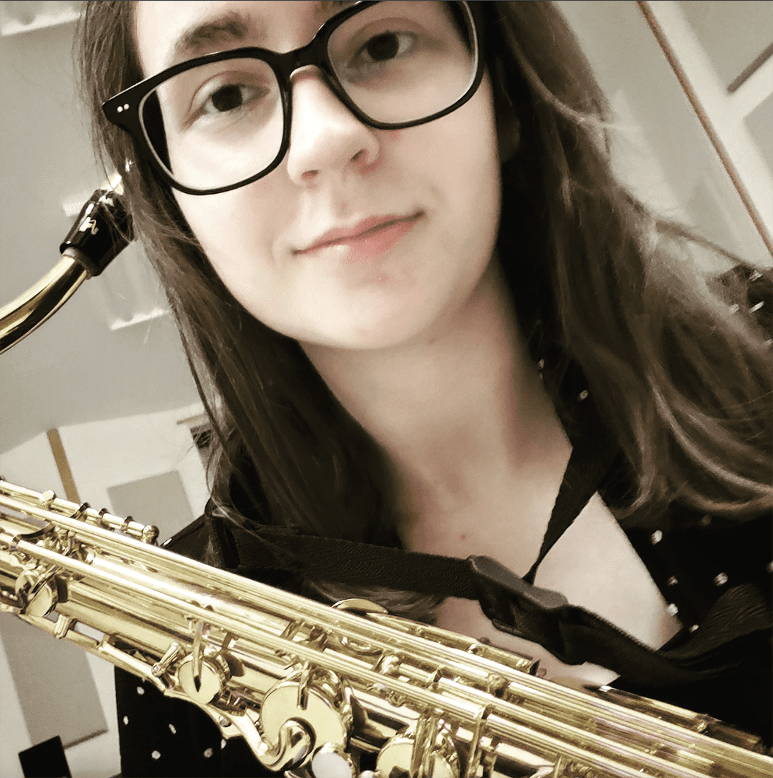 W&J senior Anna Higgins smiles with her saxaphone.